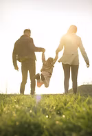 parents swinging child